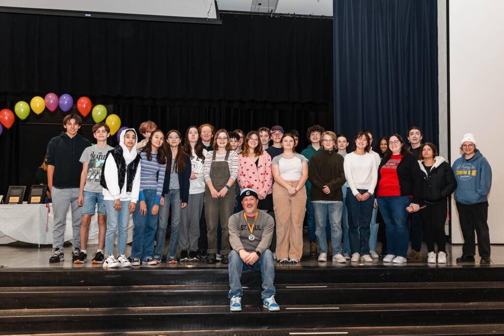 Max poses with team