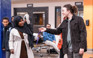 Debater accepts award from AmeriCorps member