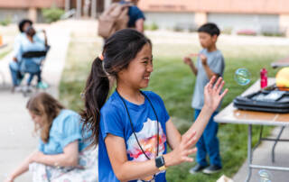 Debate camper playing with bubbles